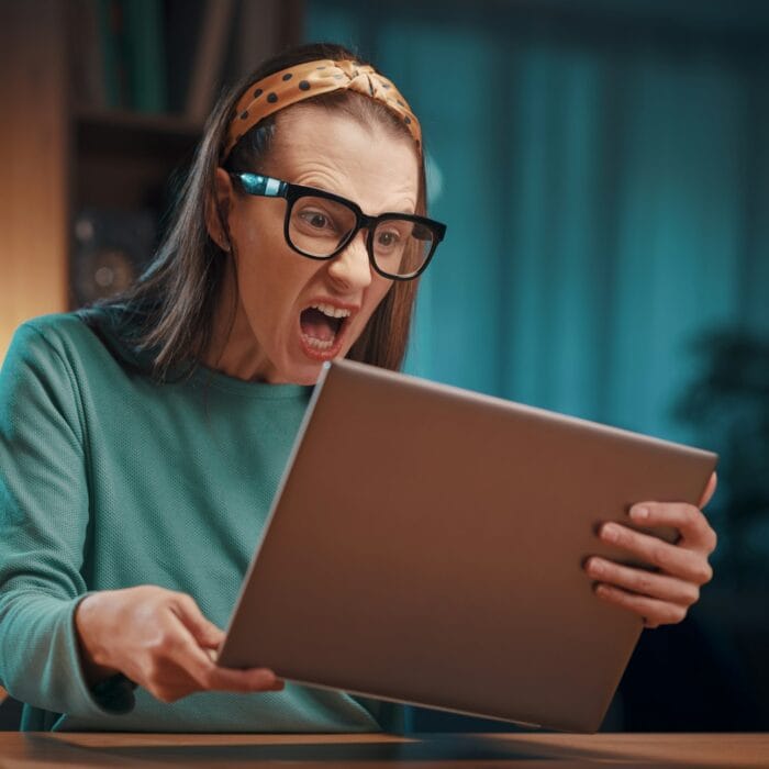 Angry woman shouting at the laptop screen
