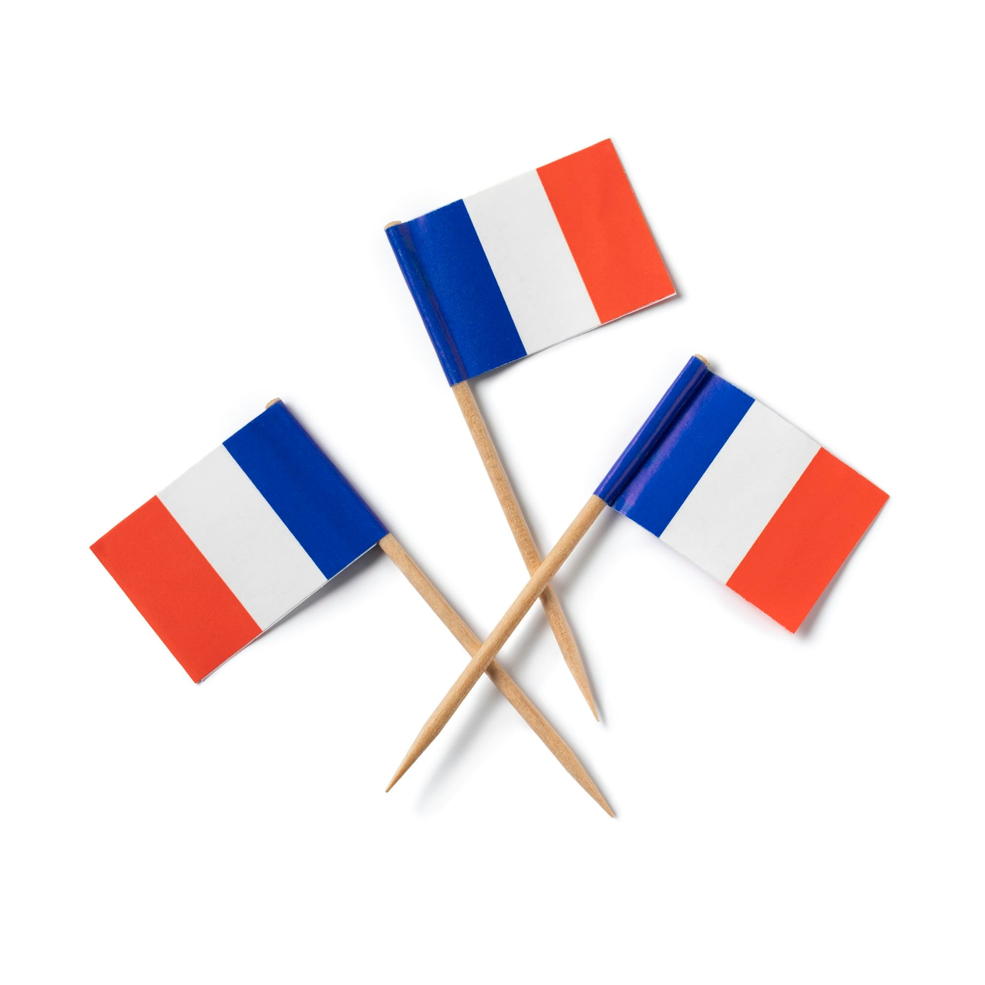 Miniature French flag cocktail sticks on white background